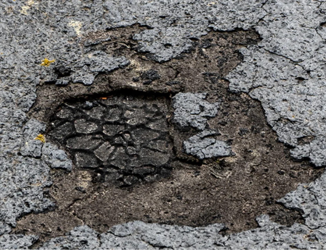 Deteriorated cap sheet membrane in a two-ply modified roof.