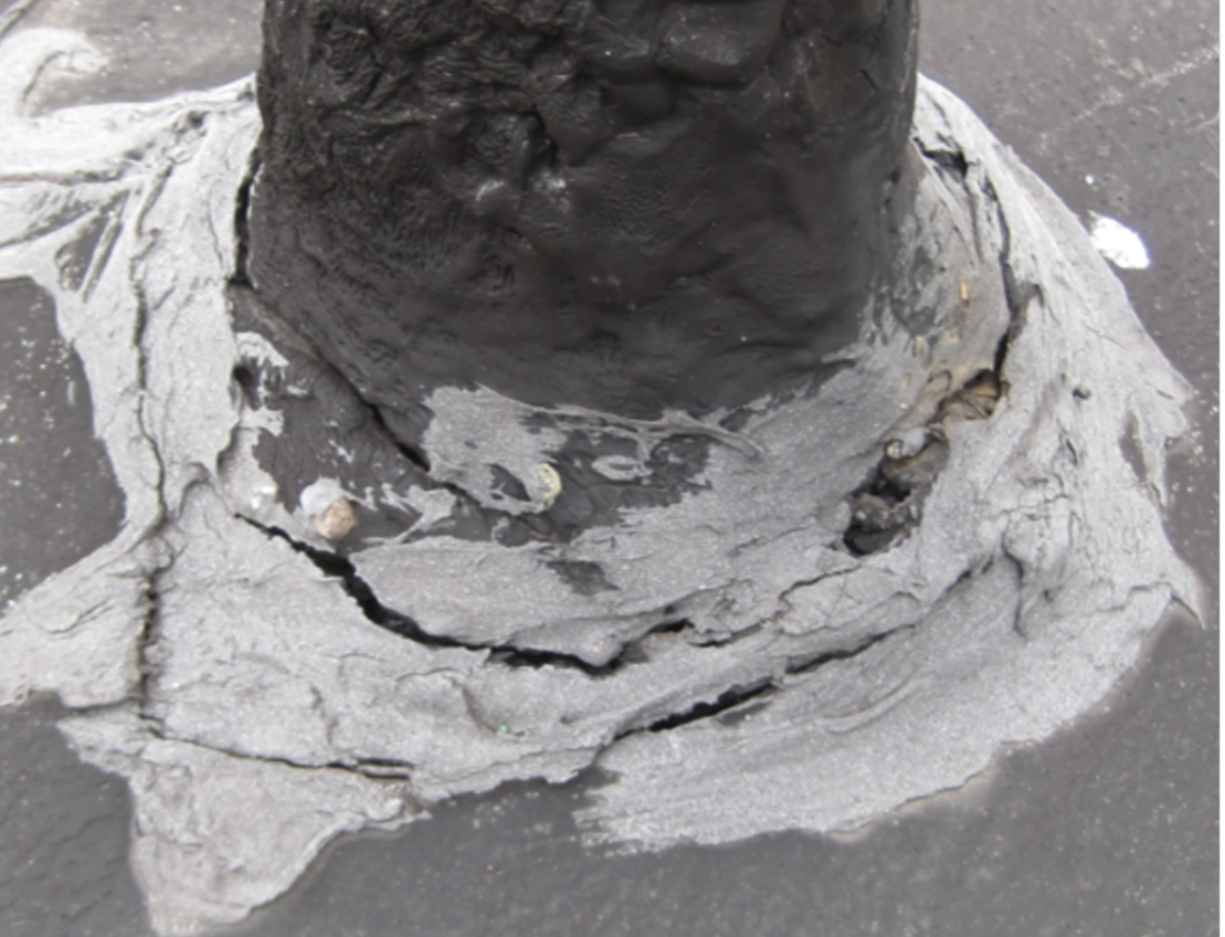 Deteriorated and cracked sealant at base of plumping stack.